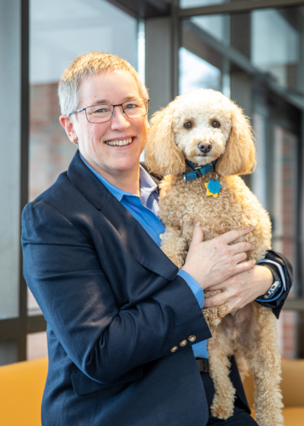 Kendra Moore, CEO of Boston Fusion, with her Goldendoodle, Nico